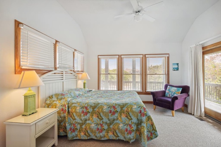 Your bright retreat awaits with vaulted ceilings, warm wood accents, and French doors opening to your private balcony. Sink into the soft linens and wake to sunlit mornings in this peaceful escape.