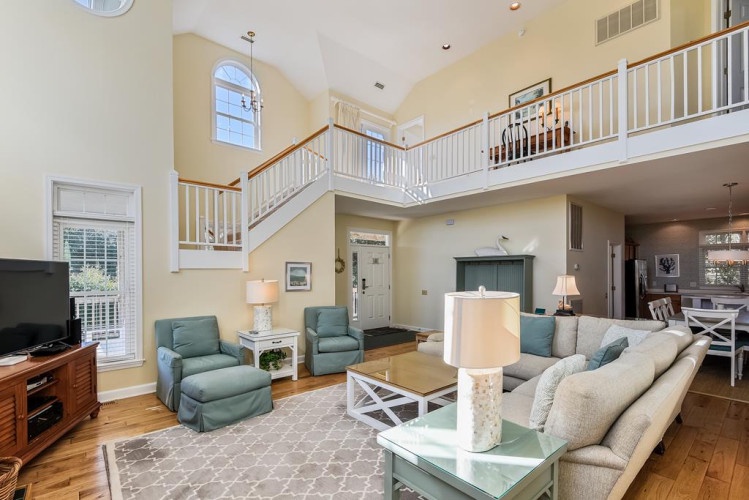 Step into your airy, sun-filled living space with soaring cathedral ceilings, a private second-floor loft, and coastal-inspired décor that invites you to unwind in comfort and style.