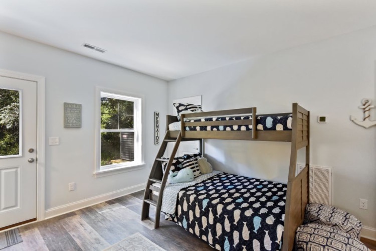 Your kids will love this bright bedroom with a sturdy bunk bed, perfect for sibling bonding or hosting friends. Natural light fills the space through large windows, while the private entry adds convenience for your stay.