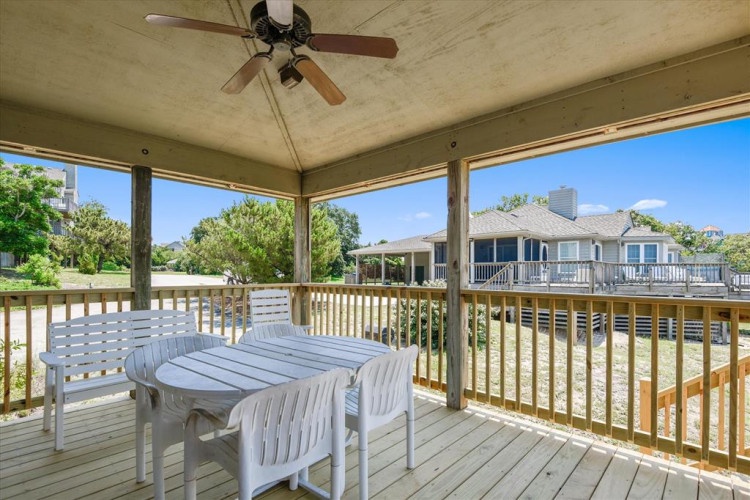 Unwind on your private covered deck with a fan overhead and peaceful views of neighboring homes and greenery. It's the perfect spot to sip your morning coffee or relax after a day of exploring.