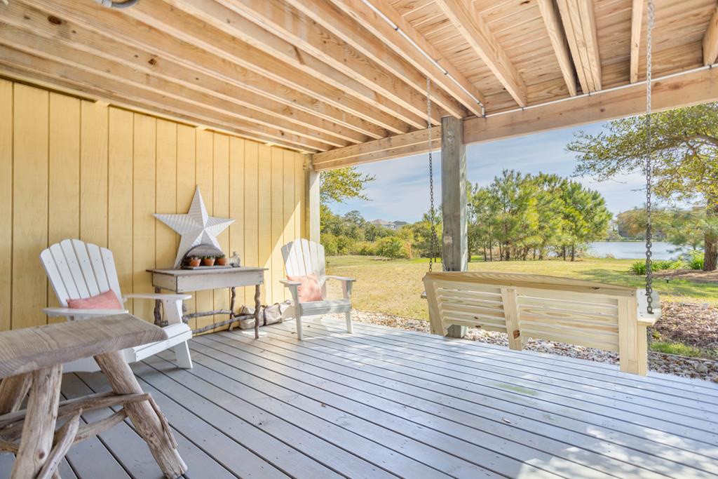Picture yourself swinging gently on your private porch, savoring morning coffee while gazing at serene lake views. This peaceful covered deck invites you to unwind in comfort surrounded by nature's beauty.