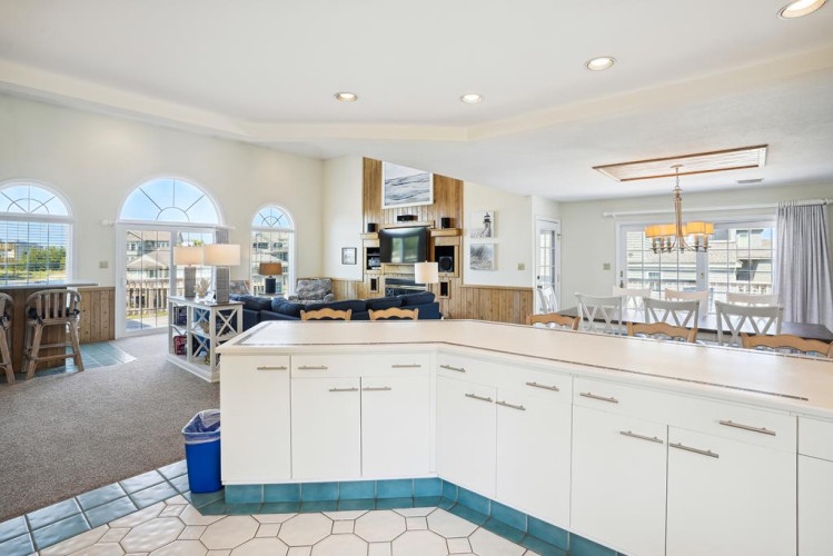 Gather around this open-concept space where the kitchen flows into a dining and living area, perfect for cooking, sharing meals, and relaxing together with friends and family.