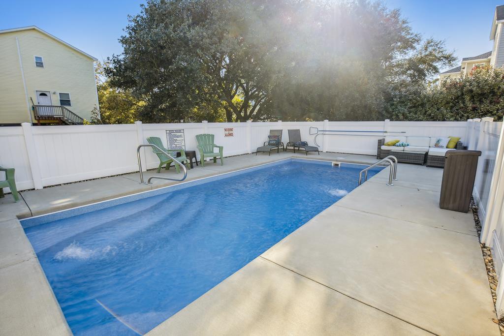 A private pool awaits, with sunny poolside loungers and Adirondack chairs set under shady trees—perfect for your leisurely afternoons and refreshing dips.
