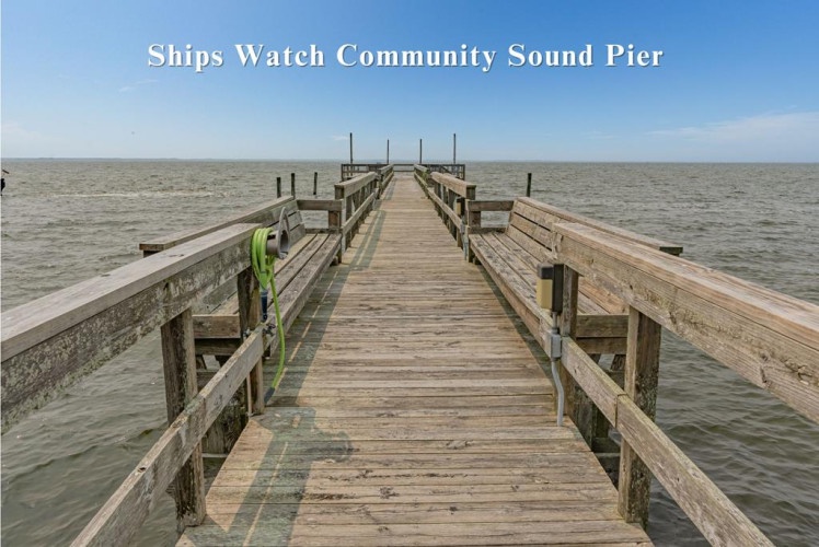 Ships Watch Community Sound Pier stretches out over calm waters, offering a peaceful setting for waterfront activities and scenic views of the surrounding natural coastline.