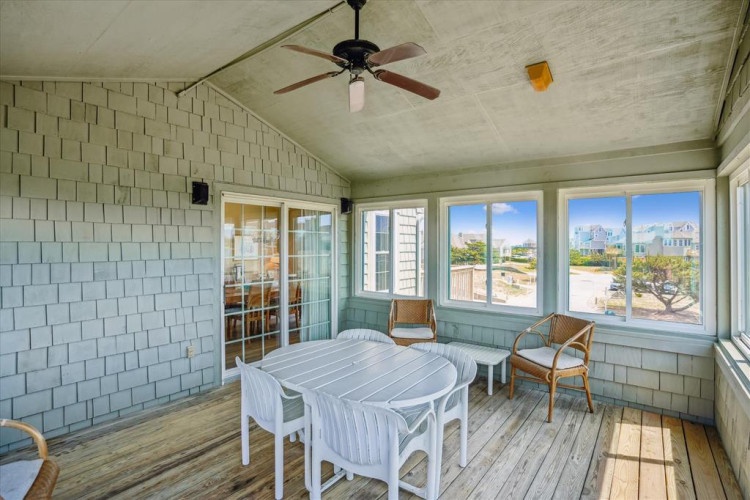Enjoy your morning coffee or evening meals at this bright, breezy screened porch—your own coastal retreat with ocean views and ceiling fan comfort.