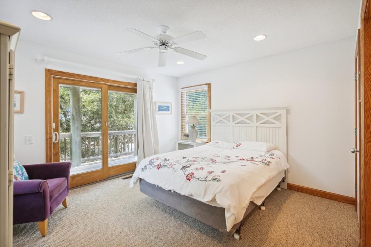Drift off in this peaceful bedroom where natural light and gentle breezes flow through. Your private balcony and cozy reading chair invite you to unwind in comfort.
