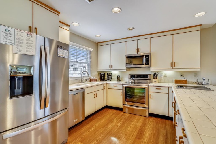 Step into a fully-equipped kitchen with stainless steel appliances, abundant counter space, and warm hardwood floors—perfect for preparing your favorite meals during your stay.