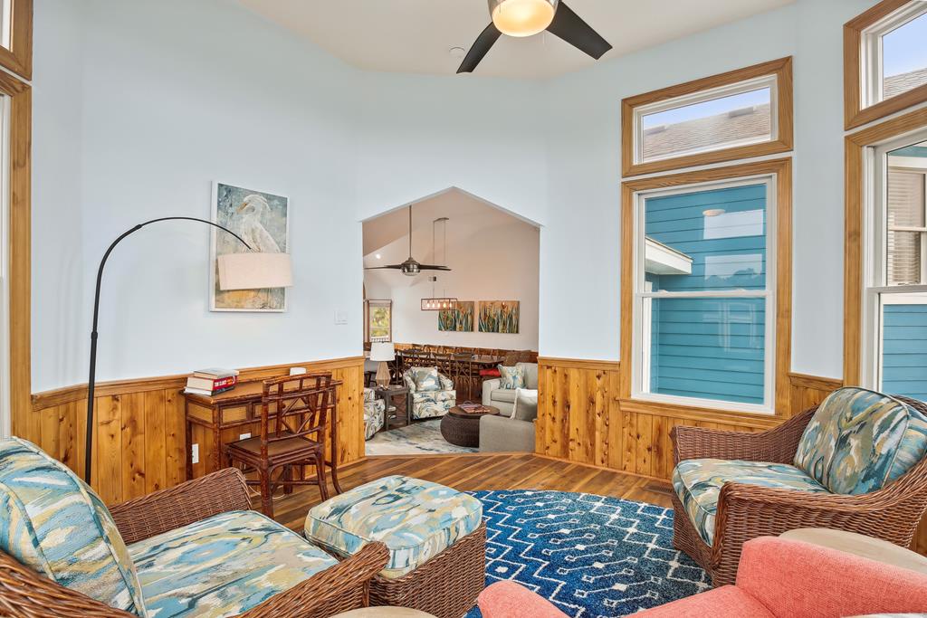 Relax in this bright, airy living space with vaulted ceilings, cozy wicker seating, and coastal-inspired decor. The open layout and warm wood accents create a welcoming retreat for your stay.