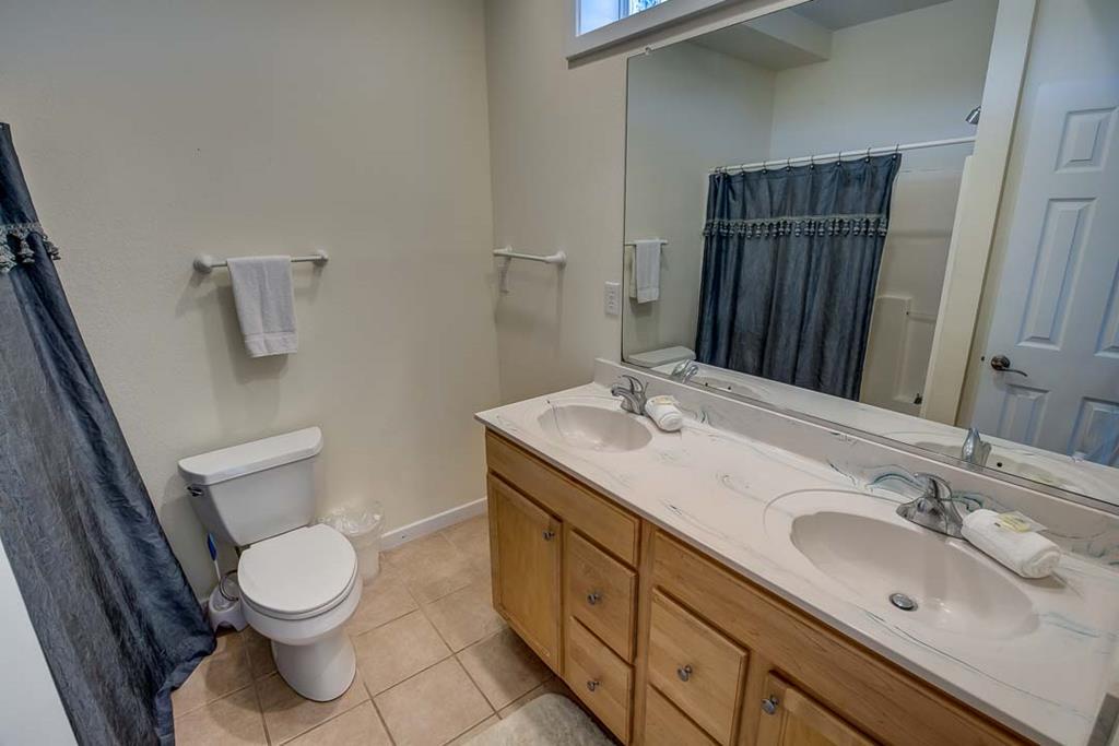 Freshen up in your private bathroom with dual sinks, plenty of counter space, and soft towels waiting for you—a bright, comfortable space to start your day.