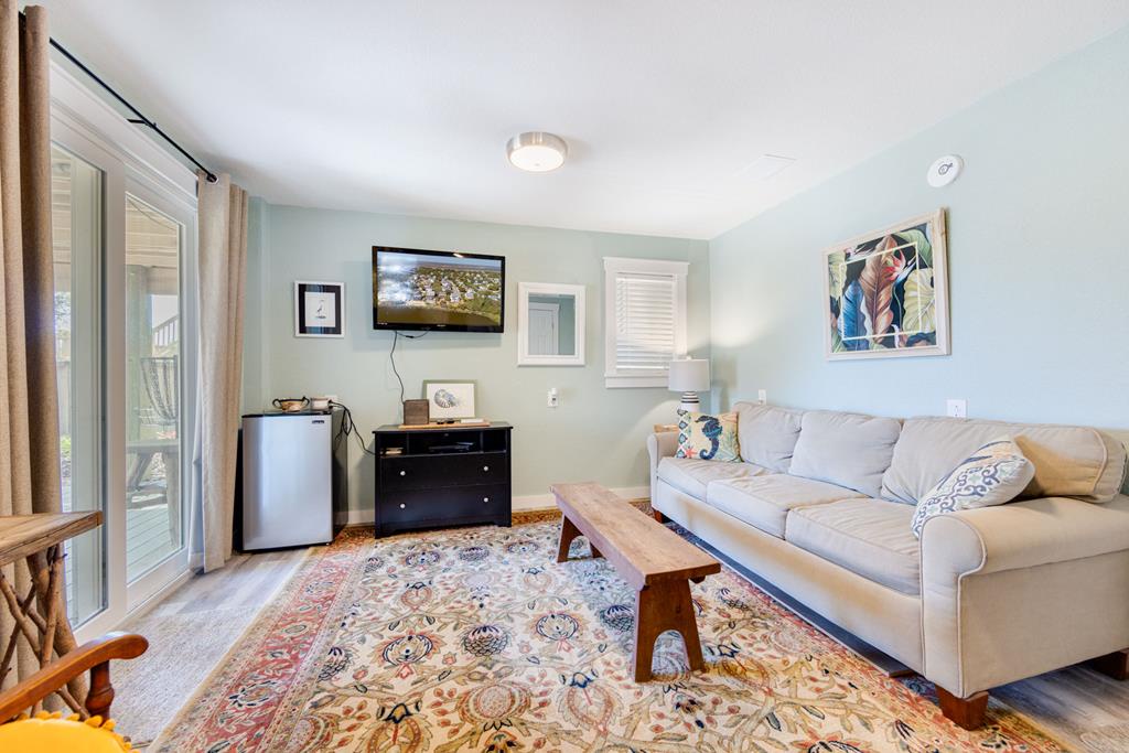 Unwind in your bright, coastal-styled living room with a comfy sofa, flat-screen TV, and mini-fridge. Soft colors and cheerful artwork create a relaxing space where you'll feel right at home.