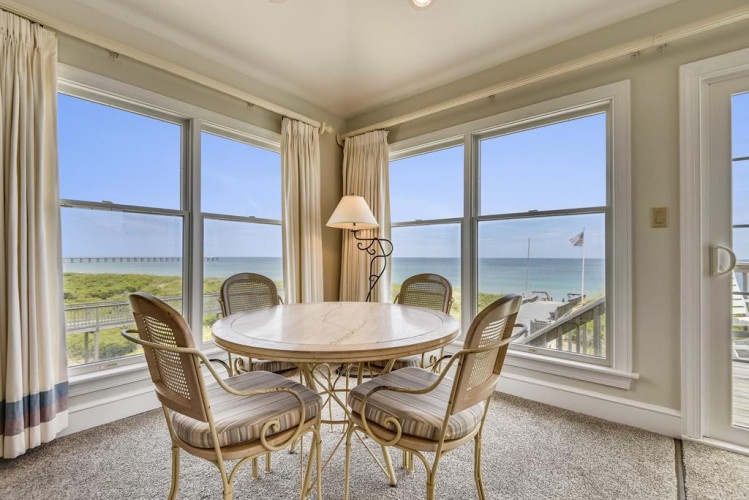 Gather around this sunlit table where sweeping sea views frame every meal. Watch sailboats drift by as you sip your morning coffee, cozy in wicker chairs with the coastline stretching endlessly beyond.