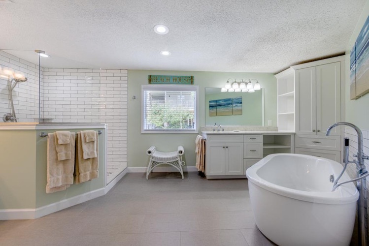 Slip into the soaking tub after a long day, or enjoy a refreshing shower in this bright, spacious bathroom complete with elegant finishes and ample storage.
