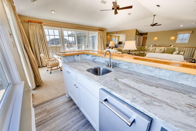 Imagine waking up in this bright, spacious suite where your private kitchenette flows seamlessly into a cozy living area and inviting sleeping space. Natural light pours through expansive windows, illuminating the elegant marble countertops and warm wood 
