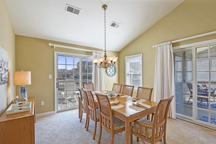 Step into your elegant dining space, where natural light fills the room and creates a warm ambiance for memorable meals with loved ones. Large glass doors frame scenic views and open to your private patio.
