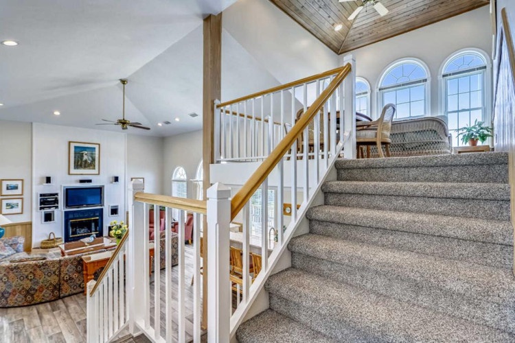 Bright open living space with vaulted ceilings and stunning natural light invites you to settle in and feel at home from the moment you arrive.
