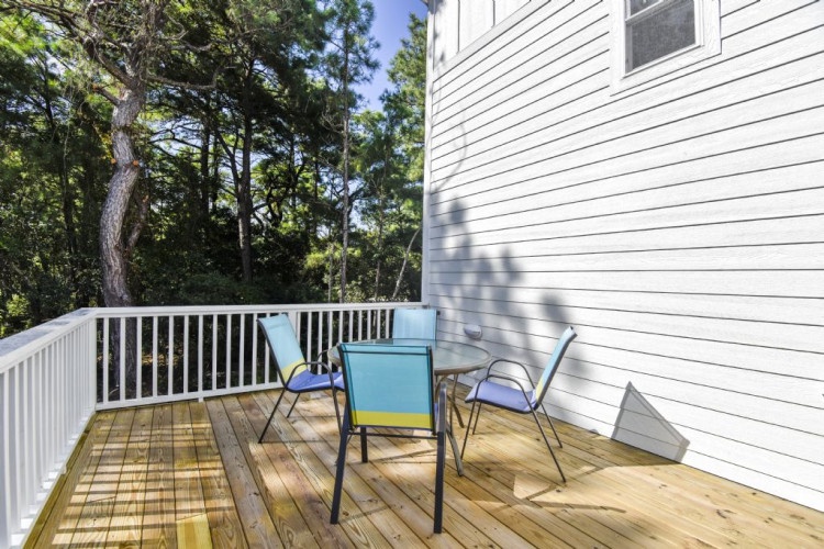 Enjoy morning coffee or evening conversations on your private deck, surrounded by lush trees and peaceful forest views.