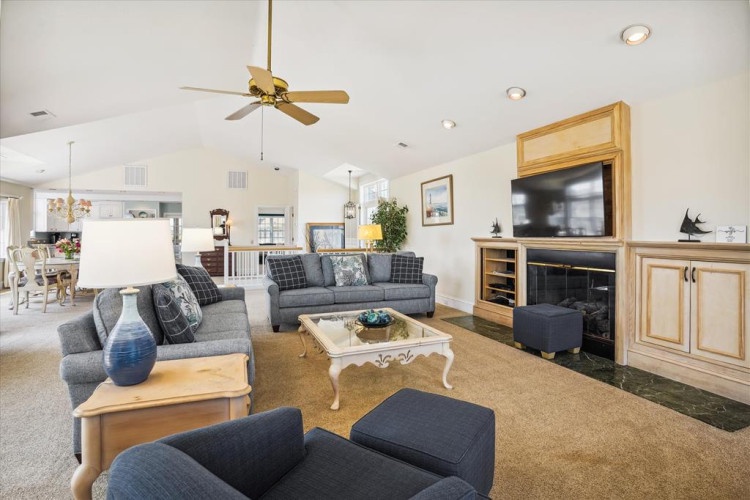 Your spacious living room invites relaxation with plush seating, entertainment center, and a cozy fireplace—perfect for unwinding after a day of adventure.