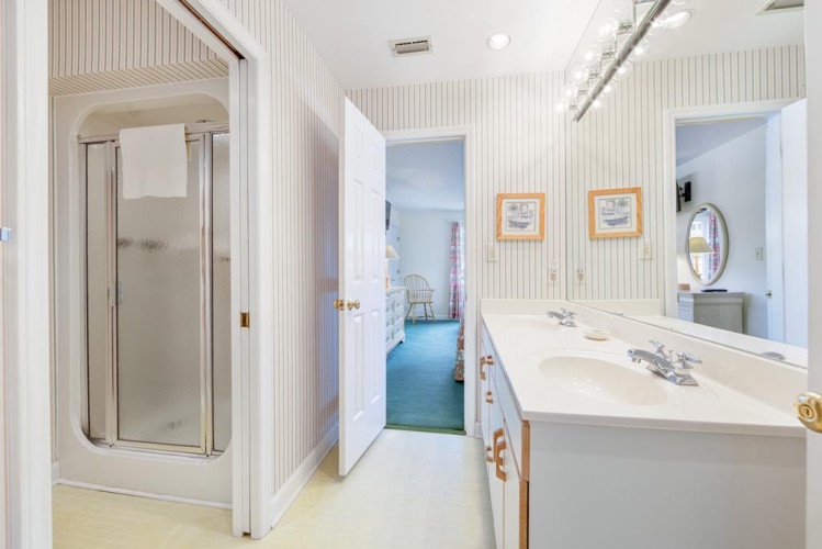 Your private bathroom offers dual sinks, a refreshing shower, and bright, clean finishes to start your day feeling refreshed.