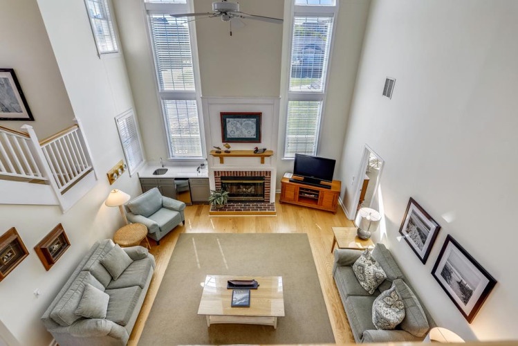 Gather in your spacious living room, where sunlight pours through tall windows onto gleaming hardwood floors. Cozy seating, a warm fireplace, and entertainment center create the perfect space to relax together after exploring.