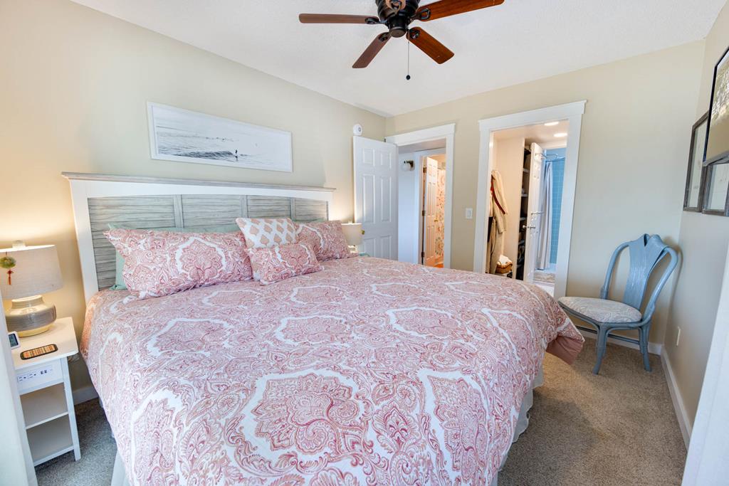 Sink into your cozy retreat featuring soft linens, gentle ceiling fan breezes, and charming coastal touches that invite you to unwind completely.