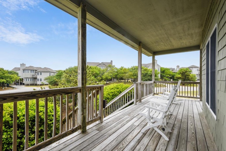 Relax in your covered porch swing, soaking in peaceful views of lush greenery and the charming neighborhood beyond—your private escape for morning coffee or evening unwinding.