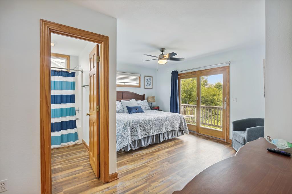 You'll love waking up in this bright bedroom with your own private balcony overlooking lush greenery. Relax in the cozy seating area or step outside for fresh morning air.