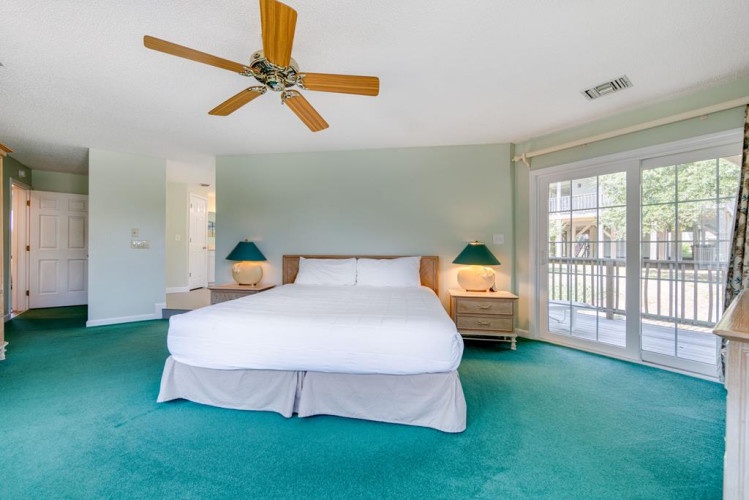 Wake up refreshed in this serene bedroom with soft mint walls and plush teal carpeting. Your private balcony offers a peaceful spot to enjoy morning coffee or evening relaxation.