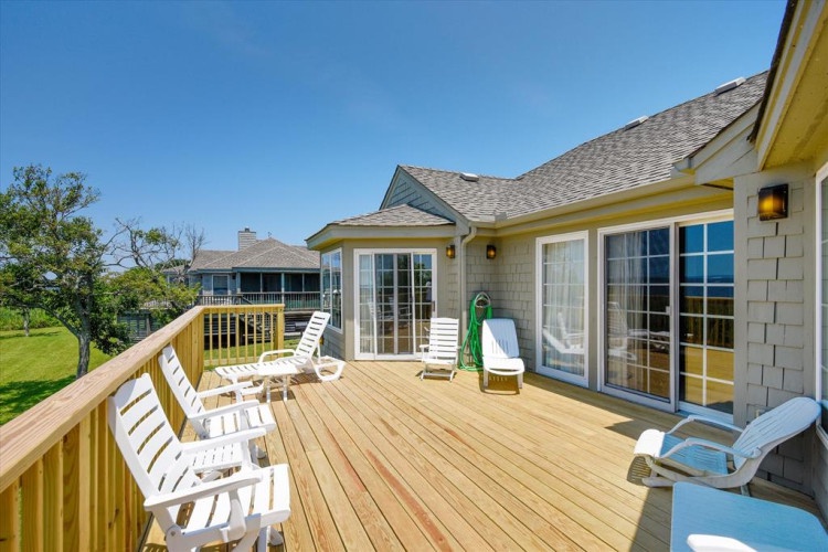 Your private deck awaits with lounge chairs perfect for soaking up sunshine and enjoying peaceful views over the surrounding greenery.
