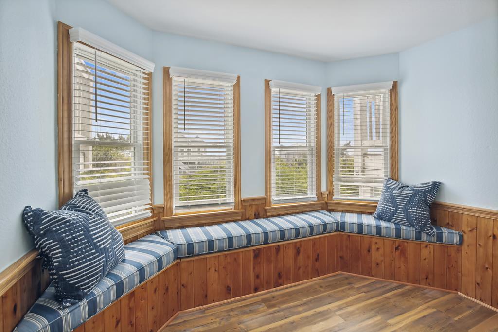 Curl up with a book in your private window nook, where plush striped cushions and natural light create the perfect reading retreat overlooking the neighborhood.