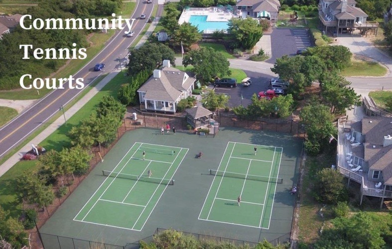 Aerial view of the community tennis courts and surrounding residential neighborhood with pool amenities and ample parking available nearby.
