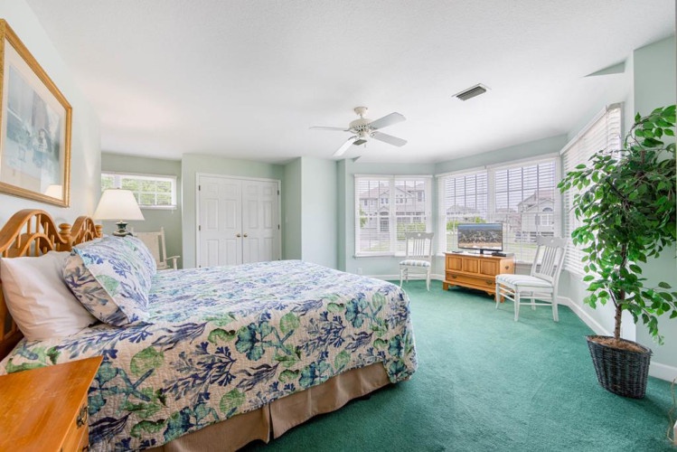 Unwind in your private retreat with coastal charm, soft natural light, and a ceiling fan for your perfect night's sleep.