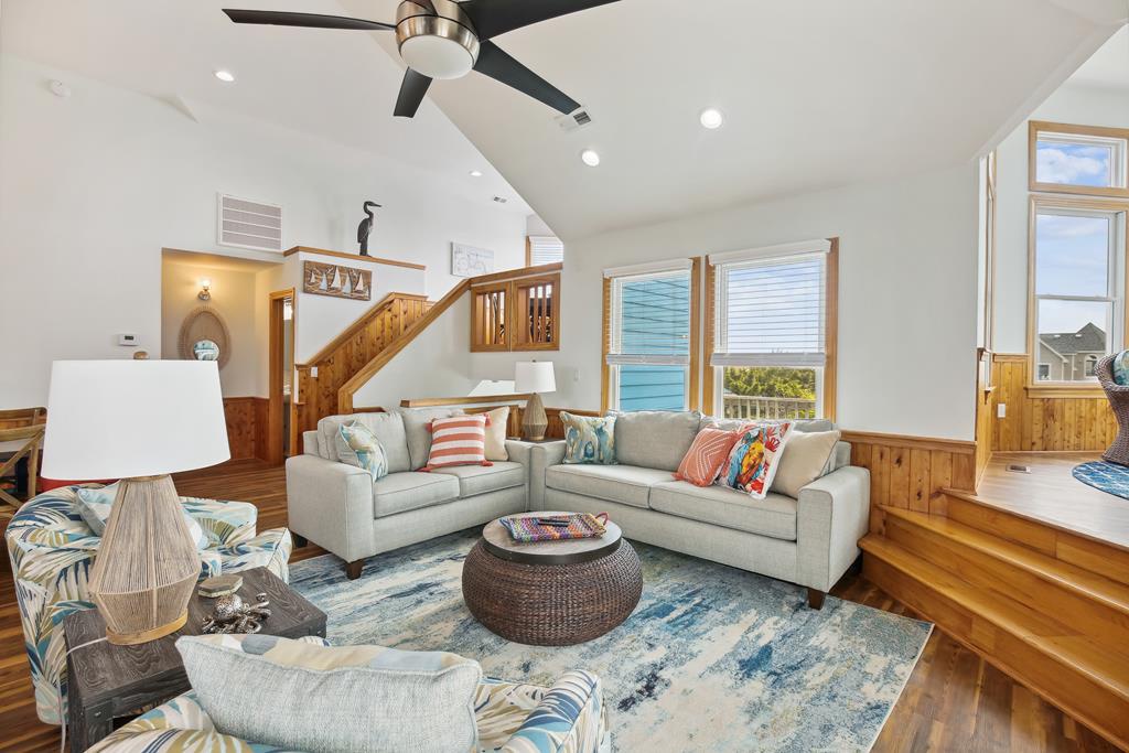 Unwind in your spacious living area, where vaulted ceilings, coastal décor, and ocean views create the perfect seaside retreat for relaxing with loved ones.