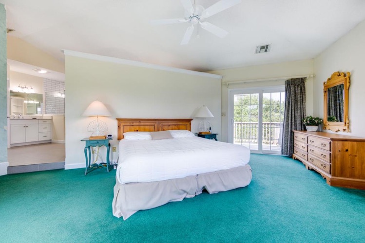 Sink into crisp linens in your spacious suite, where bright windows and a private balcony invite natural light and outdoor breezes to refresh your coastal retreat.