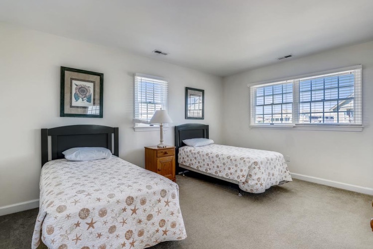 Relax in this bright guest room with two cozy twin beds, perfect for friends or family traveling together. Natural light and peaceful décor make it easy to unwind.