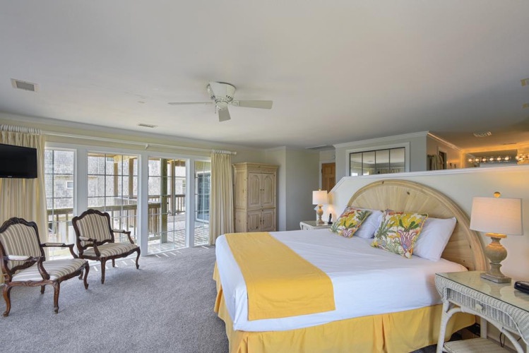 Wake up in your spacious retreat with soft natural light and private balcony access. Relax in the cozy seating area or unwind on the plush bed after exploring the area.