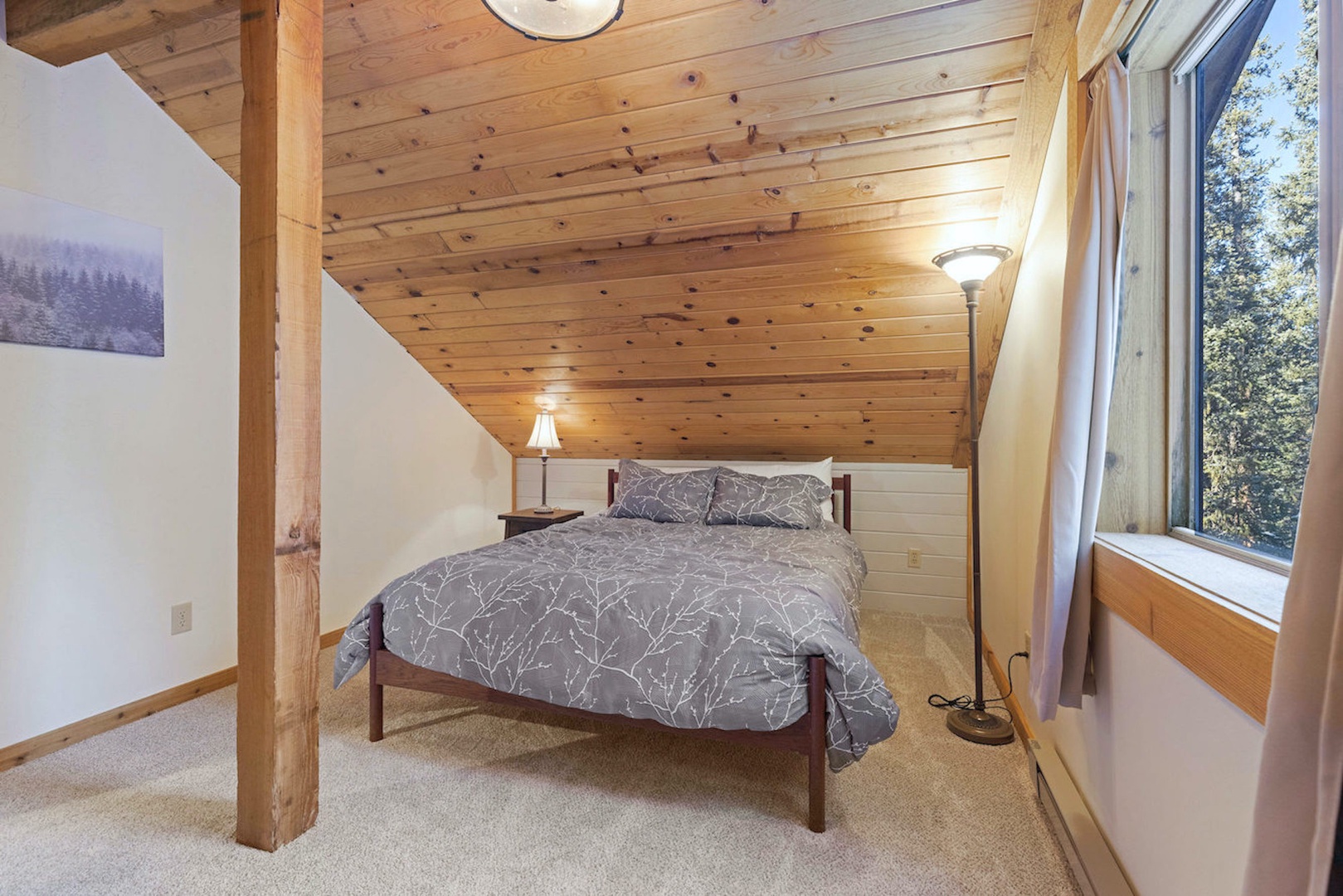 A plush queen bed & private ensuite await in this tranquil upper-level suite