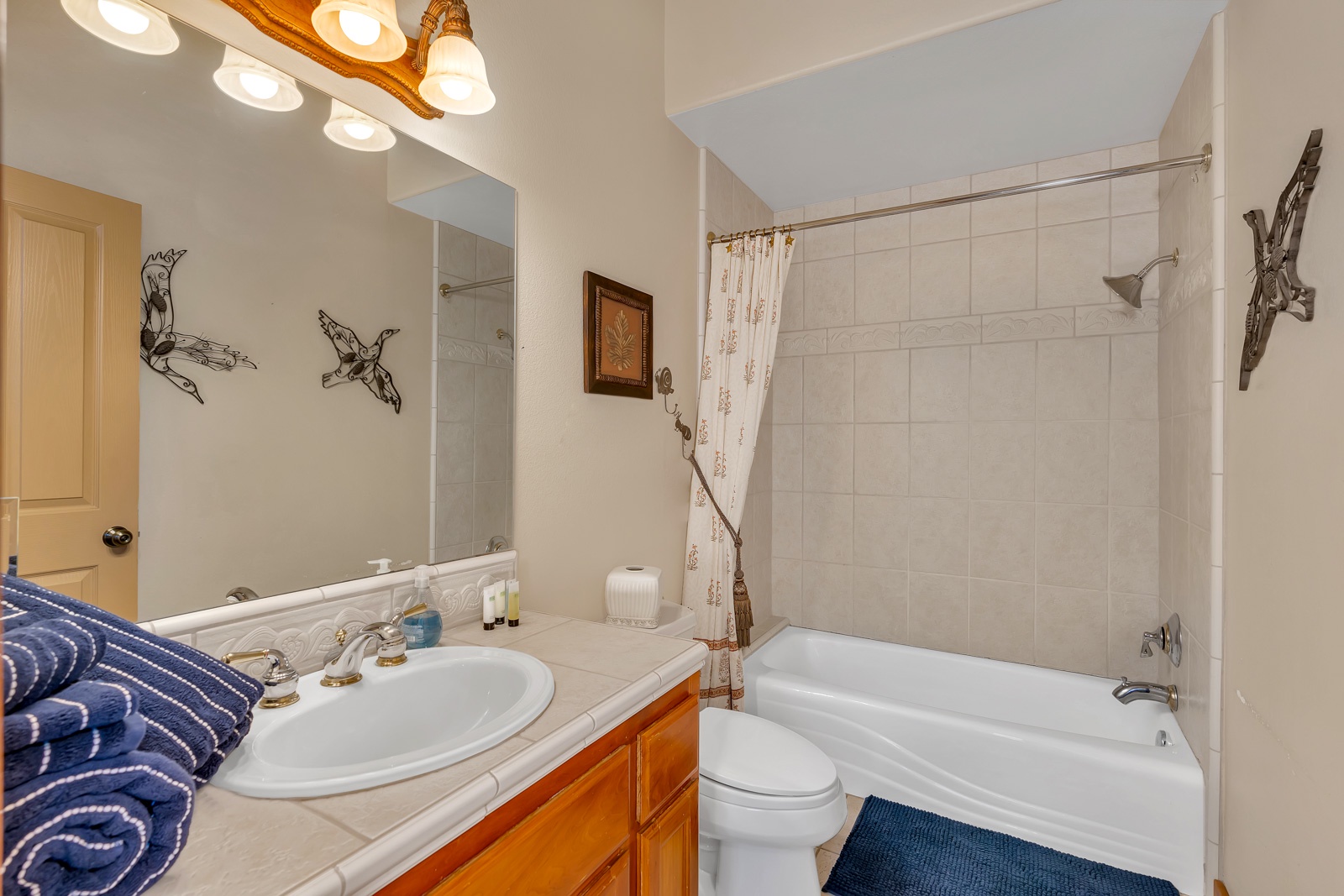 This 1st floor full bathroom includes a single vanity & shower/tub combo