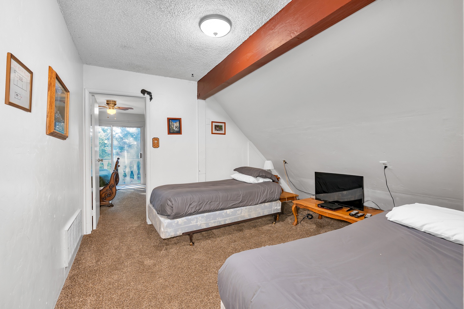 The upper-level loft includes a pair of twin beds, as well as a queen bed