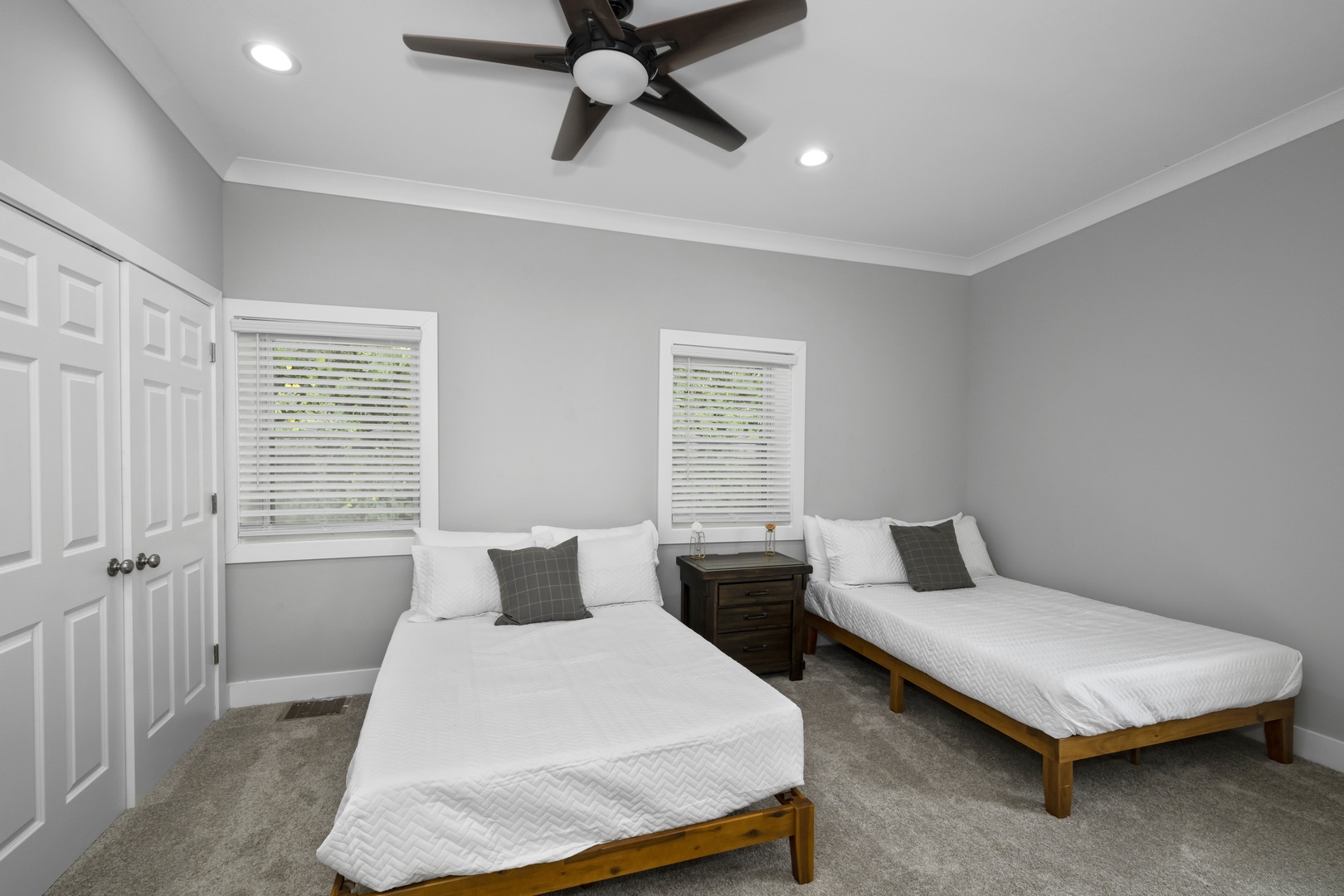 The 3rd bedroom offers a pair of queen beds, private en suite, & ceiling fan