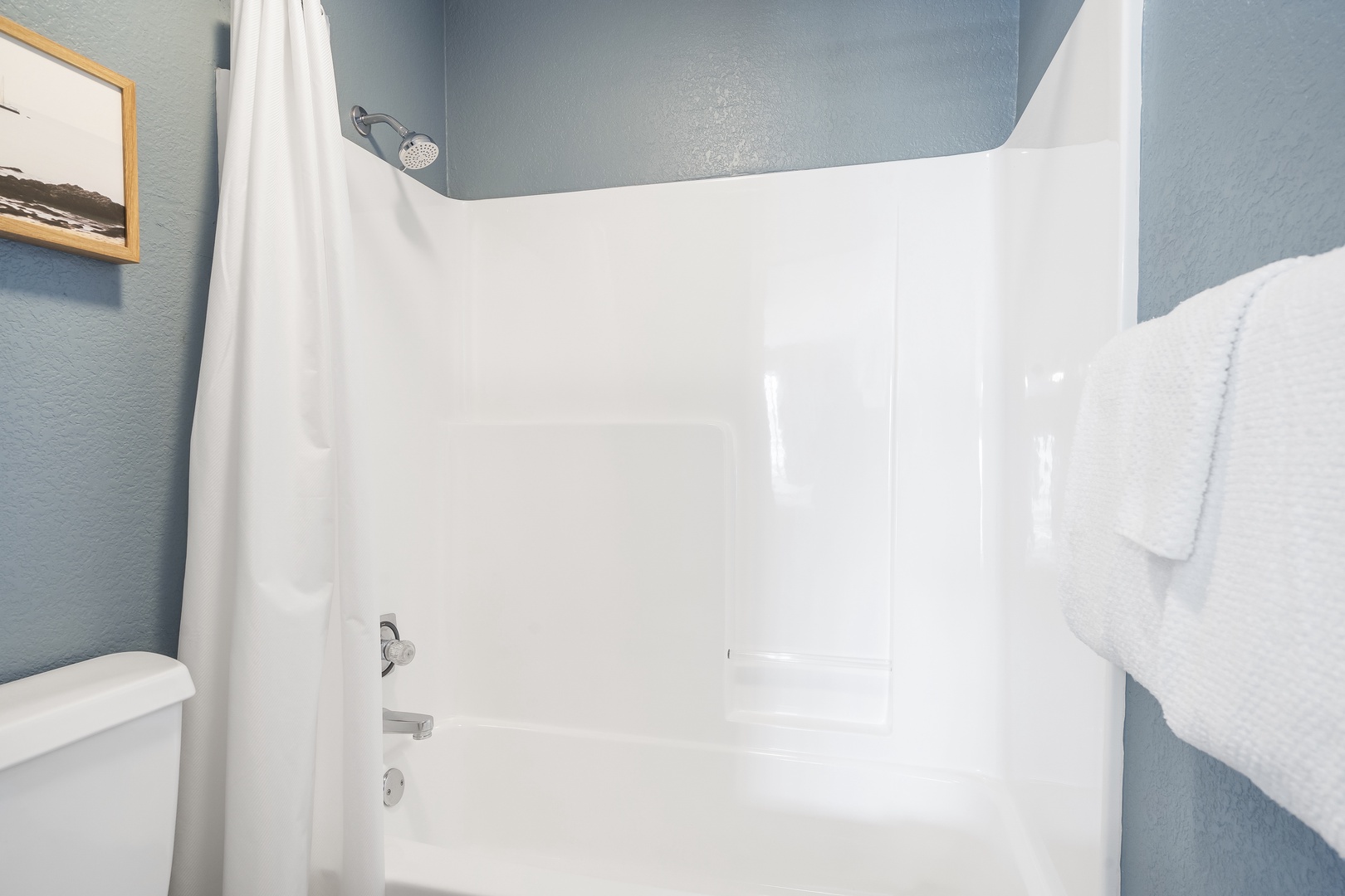 This serene ensuite offers a large vanity & shower/tub combo