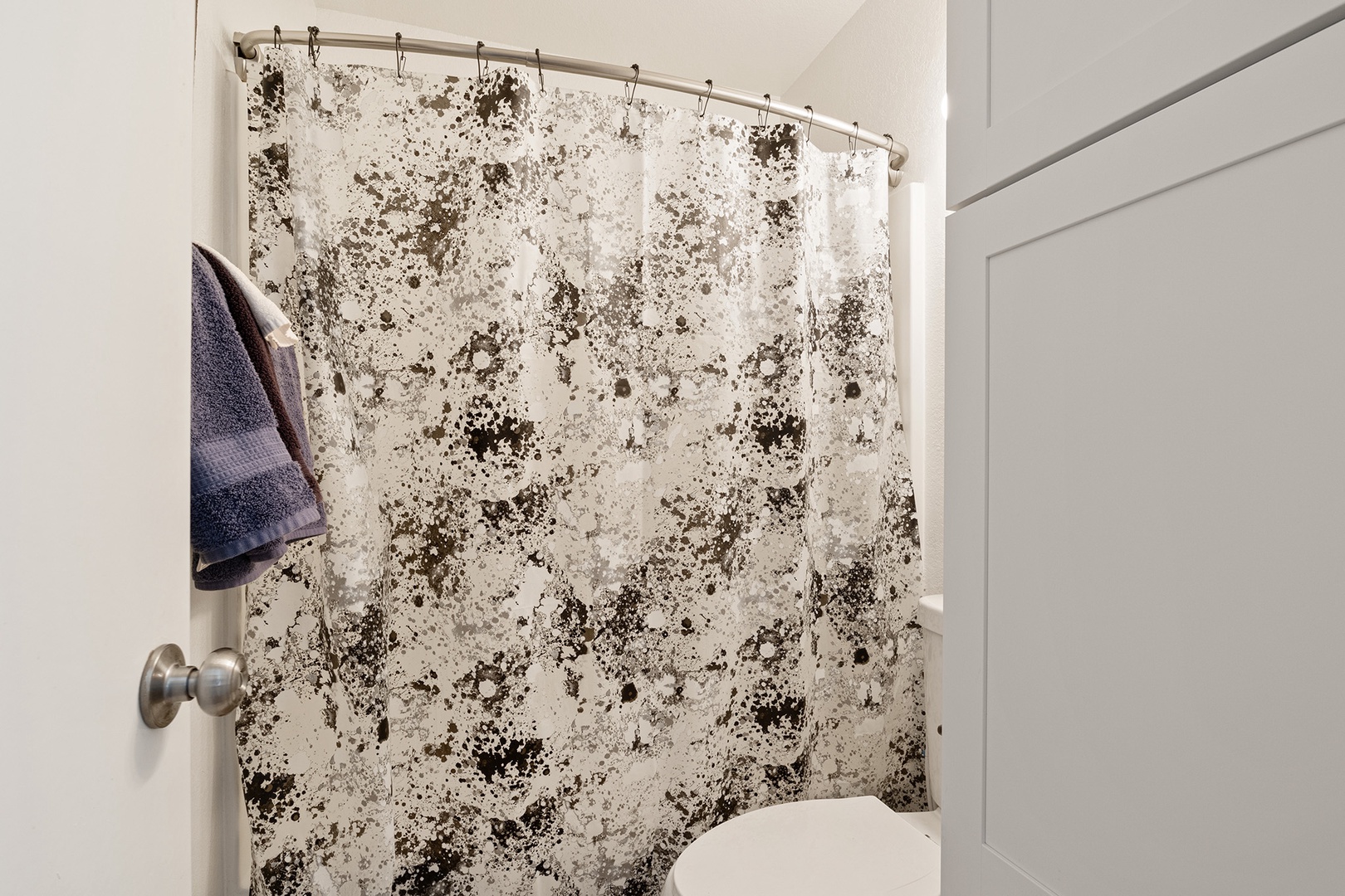 This ensuite bathroom features a shower/tub combo and a single vanity.