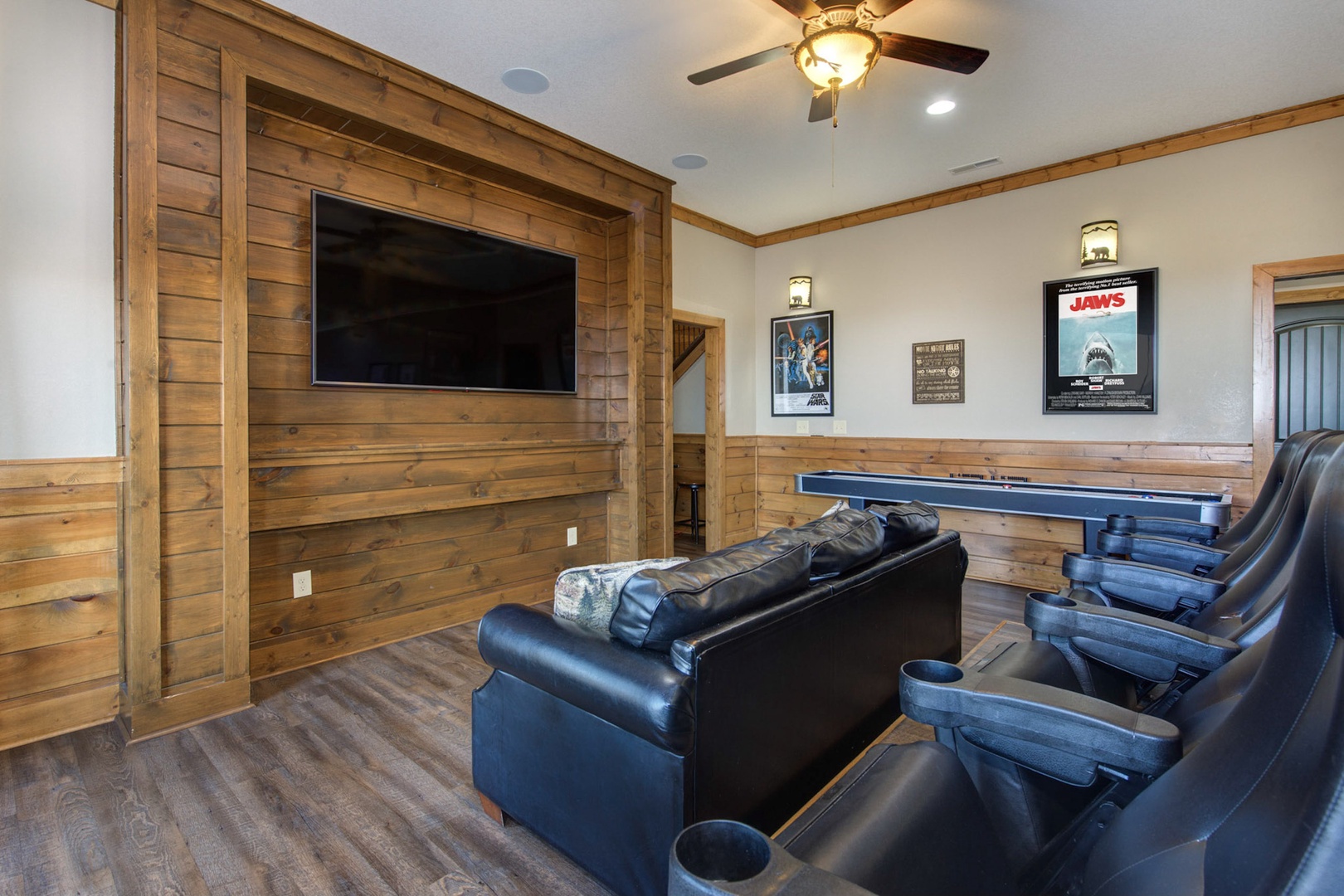 Downstairs theater room - a paradise for movie and shuffleboard enthusiasts!