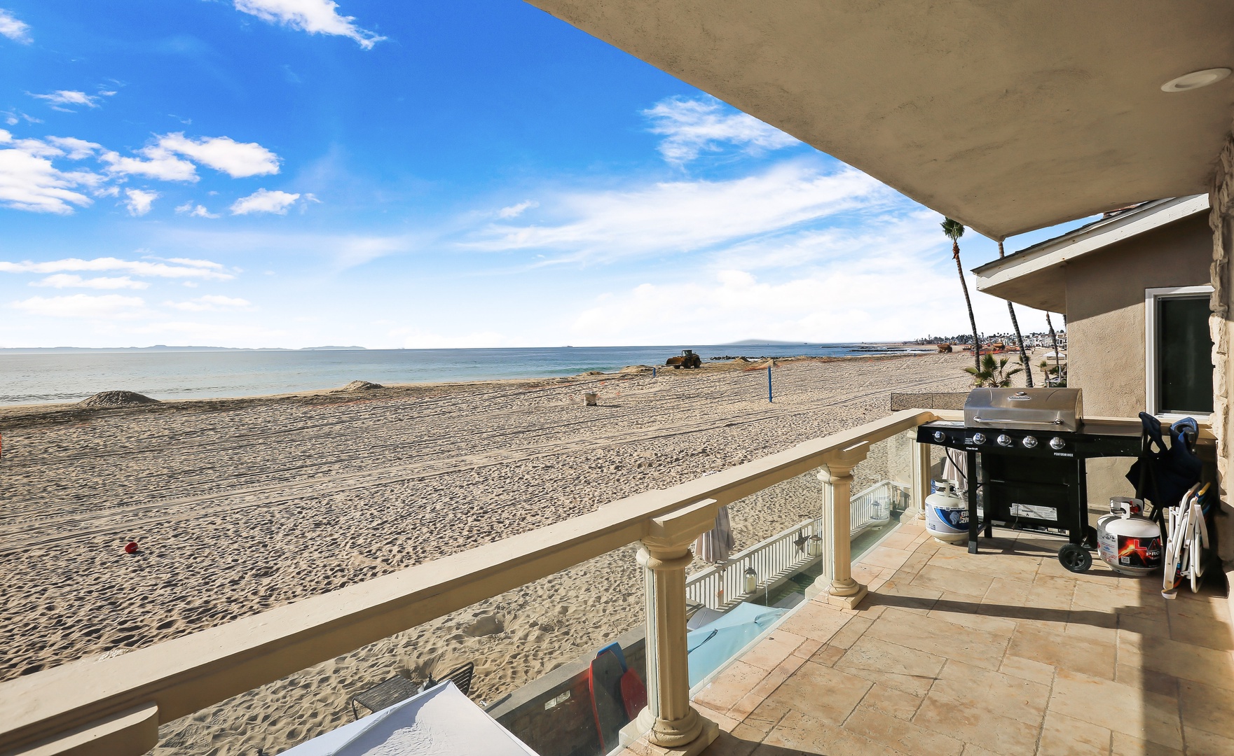 Beachfront balcony with seating and BBQ