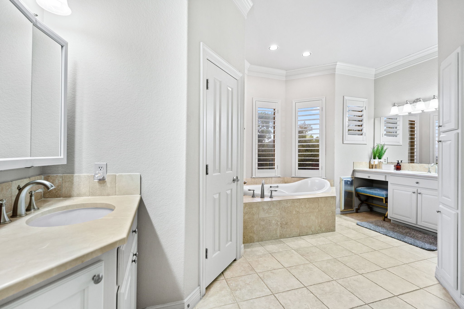 The primary king en suite offers 2 vanities, a soaking tub, & shower