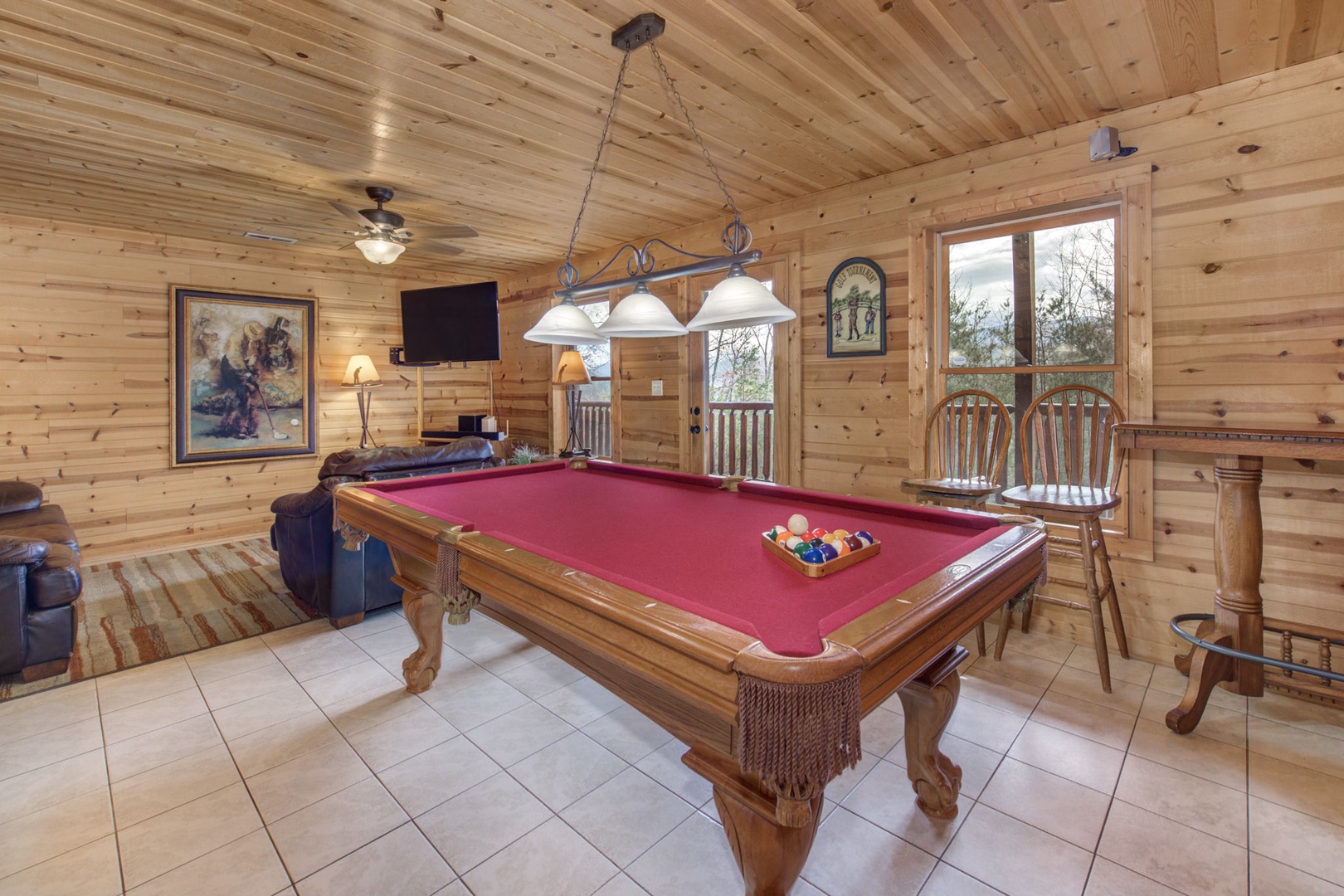 The game room retreat features a pool table, air hockey, sleeper sofa, & TV