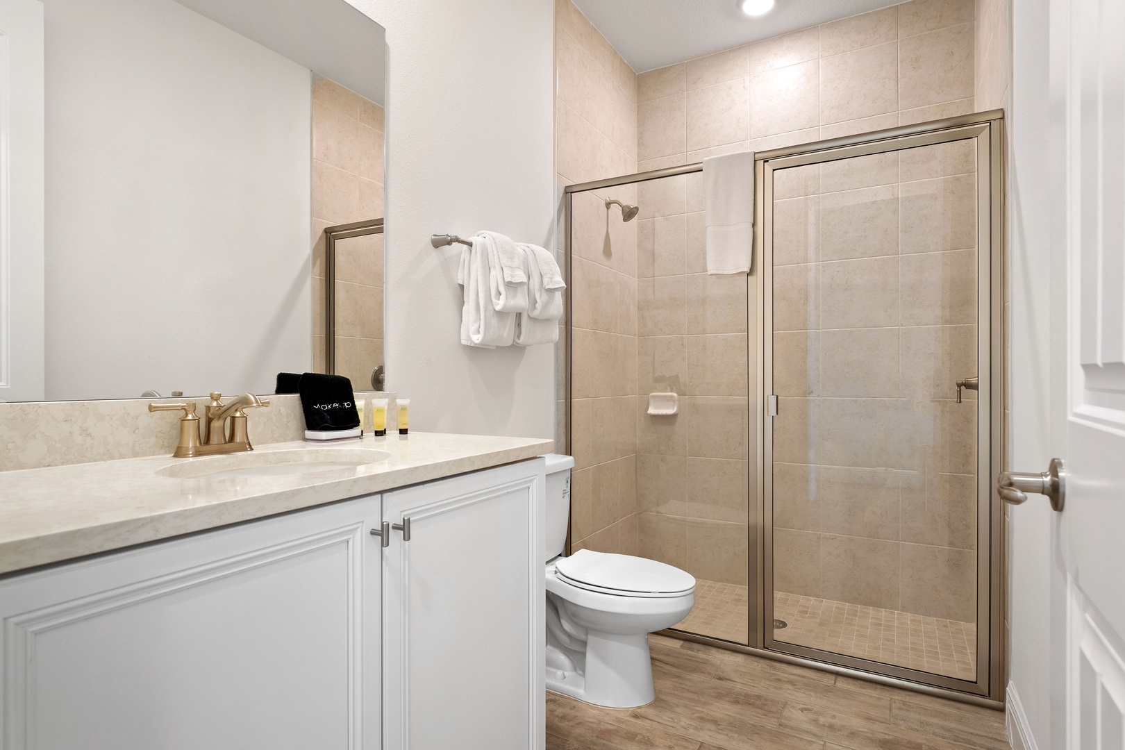 Wash up in this ensuite, featuring a single vanity with walk-in shower