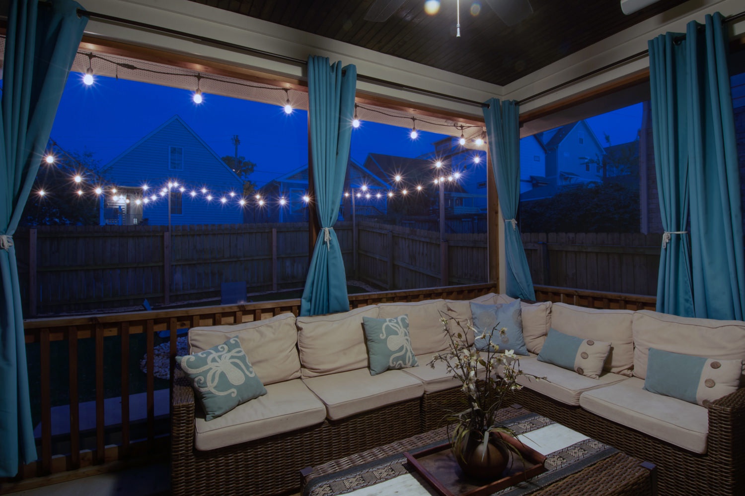 Backyard covered patio seating at night