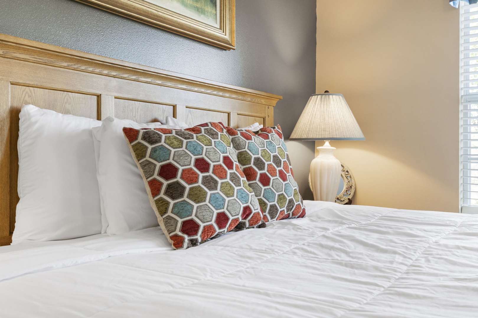 Fall into the King Bed in this main-level bedroom with En Suite Bath, TV, and Patio Access