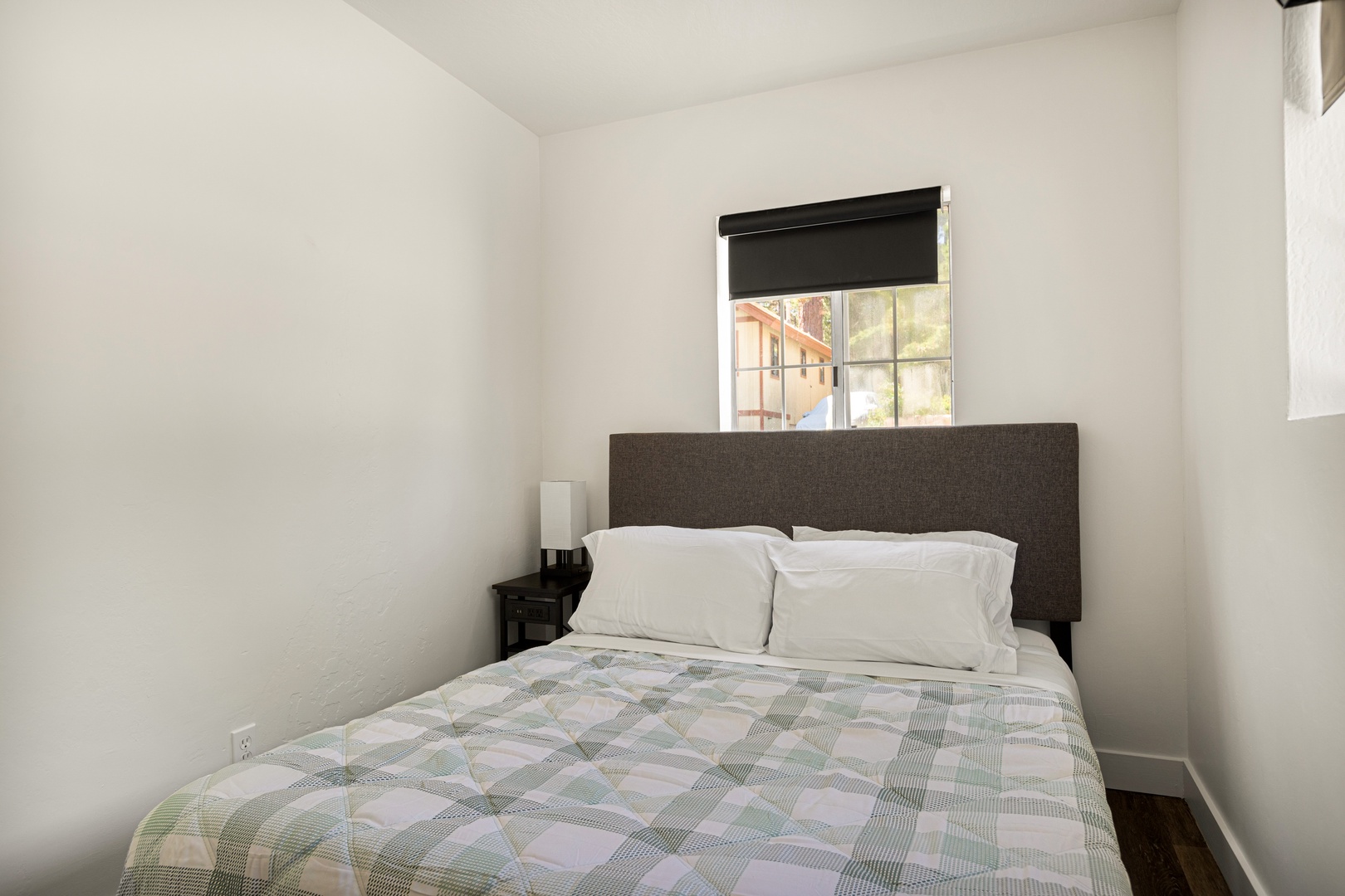 Unwind in the cozy bedroom with soft bedding and ample natural light
