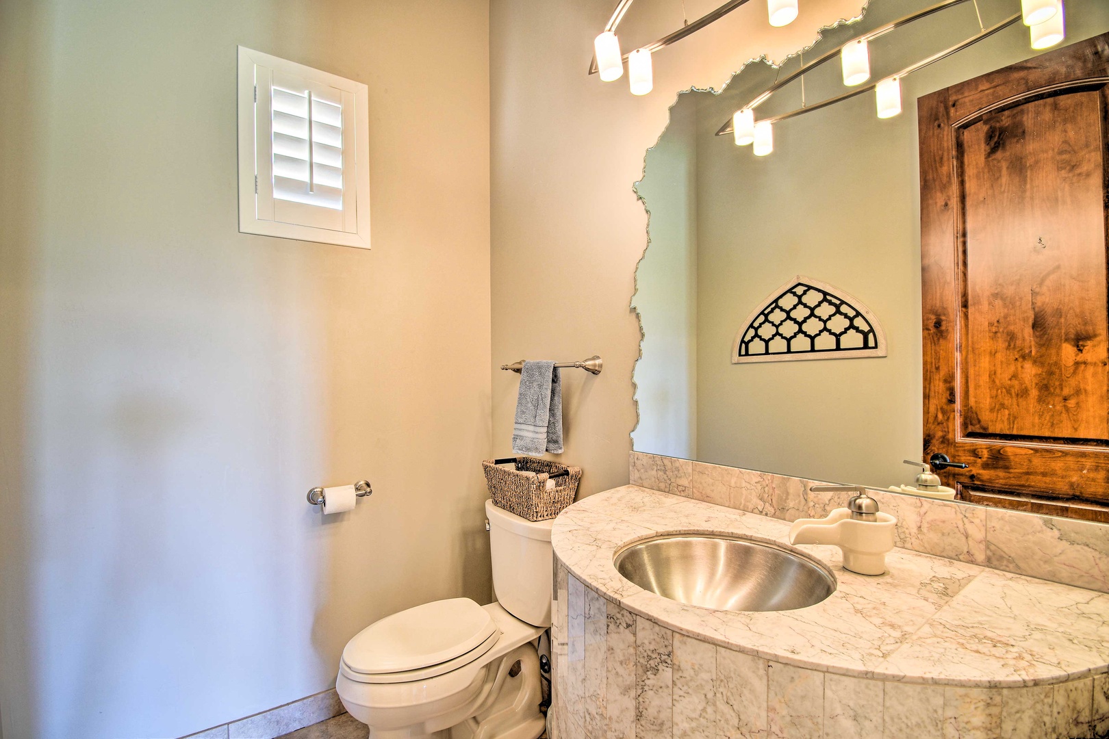An elegant powder room is conveniently tucked away